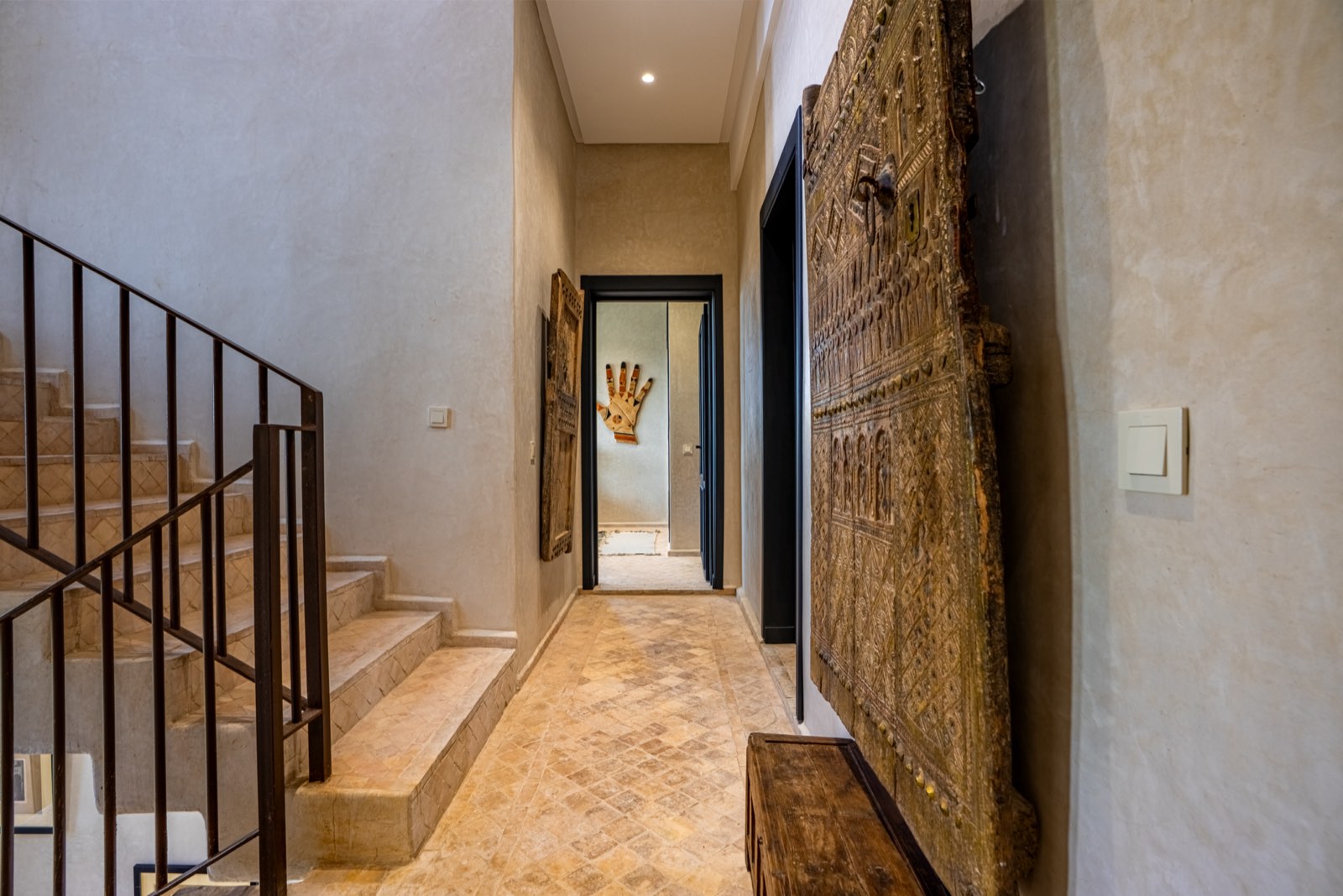 An antique carved door displayed in the hallway