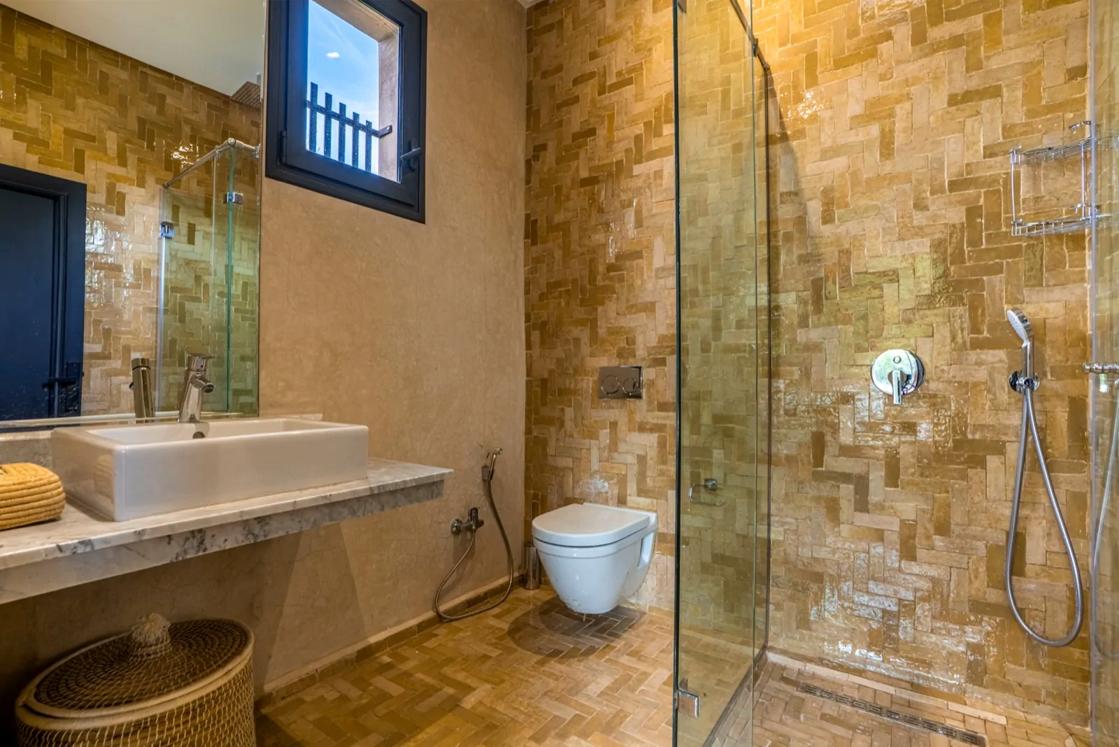 Honey-toned zellige bathroom with walk-in shower