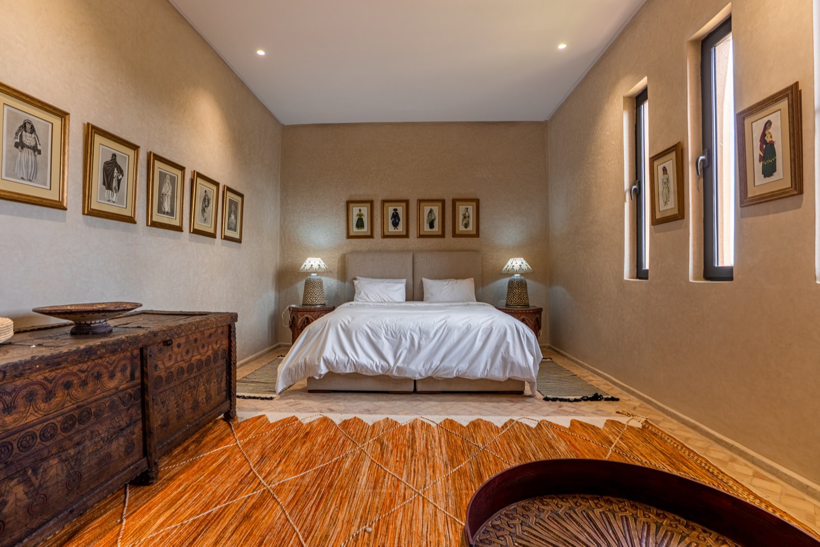 Suite Two: king-size bed beneath framed Moroccan portraits