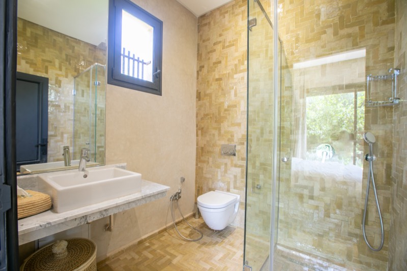 Suite Four: bathroom in sand-toned zellige with walk-in shower