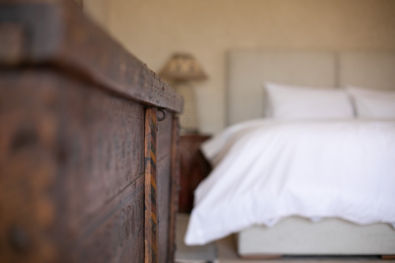 Suite Four: antique wooden chest at the foot of the bed